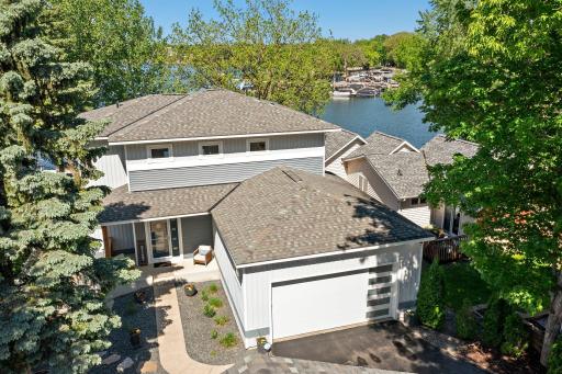 Elegant exterior welcomes you home tucked away between tall trees