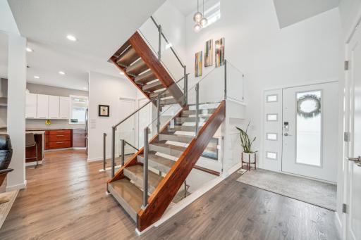 Step into a vaulted foyer that opens to the bright and airy main level