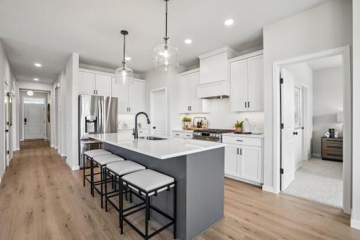 Kitchen boasts a well-planned layout with generous counter space and plentiful cabinetry for storage.
