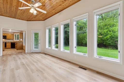 Sun room off the kitchen and primary bedroom.