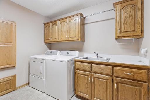 Laundry room with plenty of cabinet space and fold down ironing board