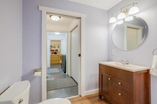The main floor powder room sits right off the hallway from the kitchen/dining area.