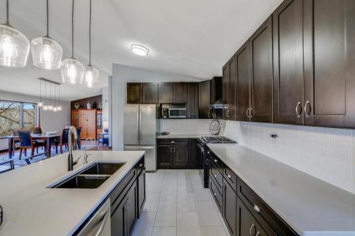 Tiled floors, stainless steel appliances and granite countertops - what more can you ask for in you new kitchen area?