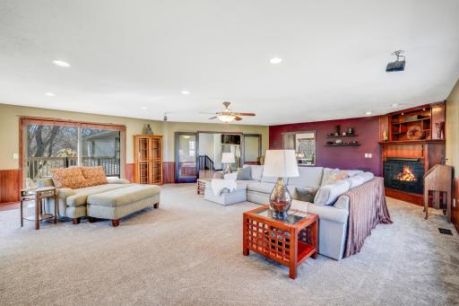 An oversized great room with a cozy gas fireplace overlooks the wooded backyard.
