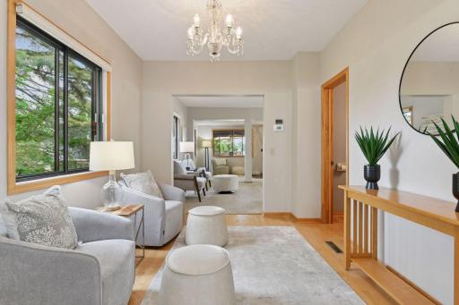 From your kitchen table, enjoy views extending toward main living room and the screened-in back porch overlooking the waterfront. This cozy Lake Minnetonka home centers its living and entertaining spaces on the scenic lakeside, where all the action.