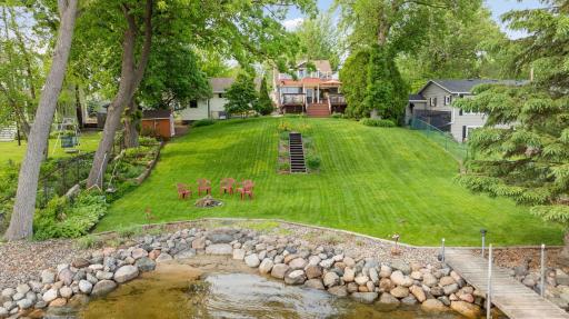 Level, sandy shoreline on Lake Minnetonka is a true rarity. Dock and covered slip included in sale.