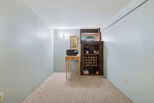 Lower-level study with a window, offering flexibility for use as a home office, hobby space, or additional guest area.