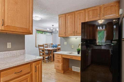 View towards informal dining space and nice work station desk in kitchen to use for paying the bills or daily paperwork.