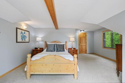 Upper primary bedroom that faces the water is generous is size with large walk in closet.