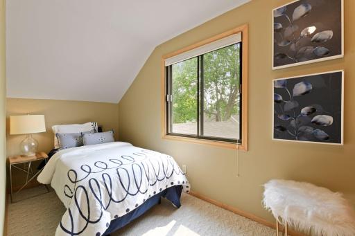 Charming third upper-level bedroom (12x5.5) with picturesque window viewsâperfect for taking in serene lake scenes and stunning sunsets.