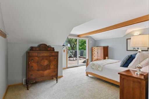 The upper-level primary bedroom (17x13) features stunning water views and direct access to an expansive balcony deckâan ideal setting for morning coffee or quiet relaxation overlooking the lake.