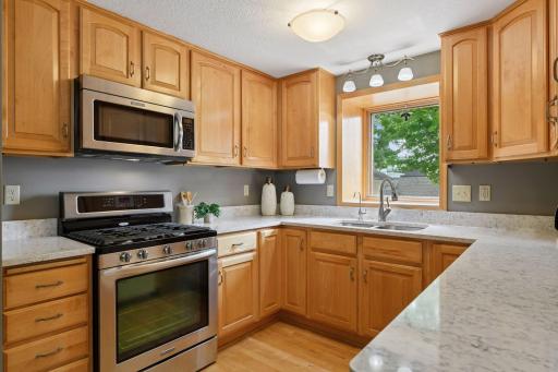 Updated kitchen with quartz counter tops, undermount sink, gas range, and more! Nice cabinetry space offering lots of storage.