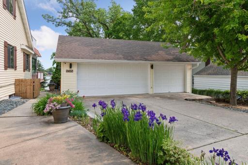 A concrete walkway leads to a latched gate, offering easy access to the backyard deck and lakefront whenever you desire.