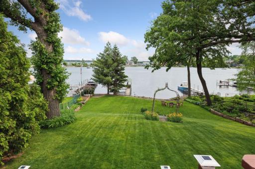 The stunning backyard could be yoursâperfect for hosting weddings, celebrations, or casual gatherings. A gentle slope leads to your waterfront, surrounded by lush landscaping, vibrant flower gardens, and breathtaking sunsets 4 unforgettable evenings