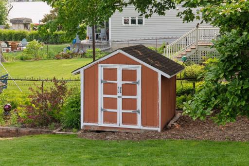 Convenient outdoor boat shed provides ample storage for all your boating gear and lakefront essentialsâkeeping everything organized and ready for life on the water.