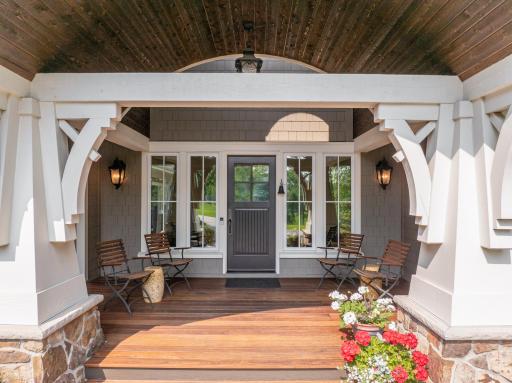 Natural light from large windows flanking the front door + an arched transom window high up within the vault