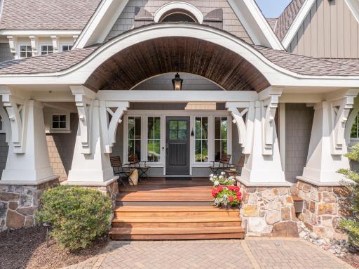 Brazilian Teak front porch showcases an elegant barrel vault which transitions to a more dramatic, 2-story angled vault as you approach the front door.