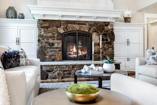 Cozy stacked stone gas fireplace anchors the great room.