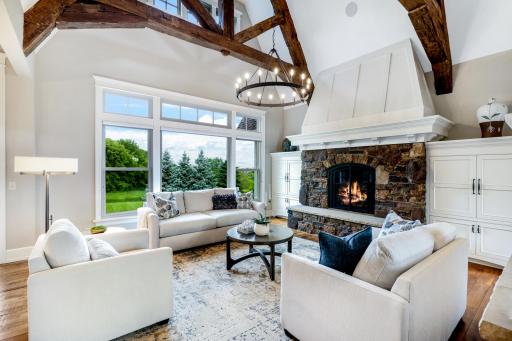 Custom enameled built-ins with crown molding tops flank the fireplace for media & storage.