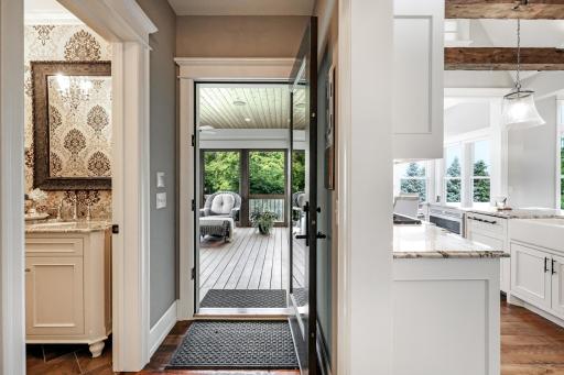 Dual entry doors to the 3 season porch. Sliding glass door connects to the dining area + separate glass door leads to the back hallway.