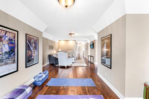Large, open space highlighted by sloped edge ceilings, dormer accents, and multiple large windows.