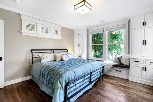 Bedroom 1: crown molding, large window w/padded window seat & flanking enameled built-ins, upper transom windows, walk-in closet, and Â¾ bath located conveniently nearby (tile floors, granite counter.
