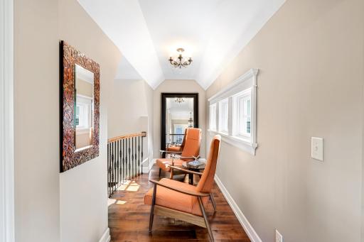A cozy niche with open views of the kitchen area below and natural light from multiple sources.