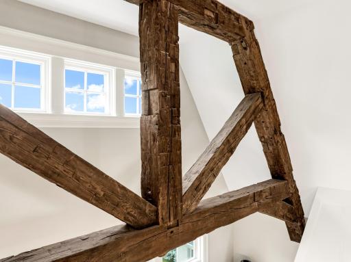 2-story vault with reclaimed hand-hewn timber beams spanning the width of the space.