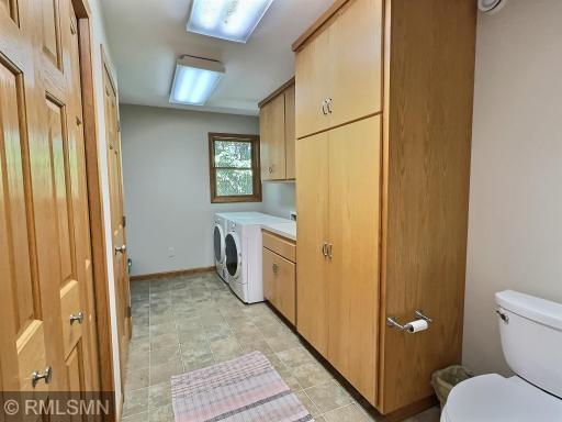 Conveniently located on the main level, this spacious laundry room offers abundant built-in cabinetry, folding space, and natural light.