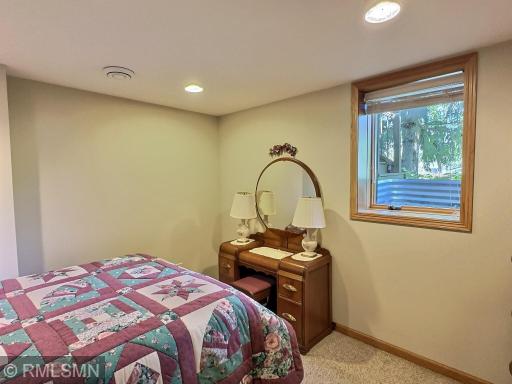 This lower-level office is currently set up as a cozy bedroom, offering flexibility to meet your needs. A large egress window allows for natural light.