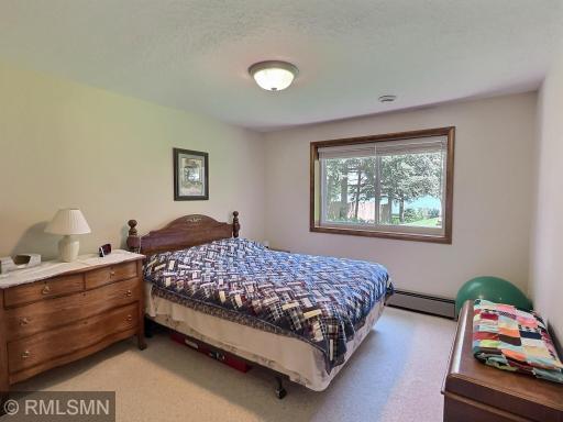 The fourth bedroom offers tranquil views of Sugar Lake through a large picture window, making it a peaceful retreat for guests or family.