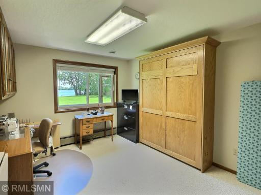 This versatile bedroom is currently set up as a hobby and craft room, offering inspiring lake views and natural light that fills the room.