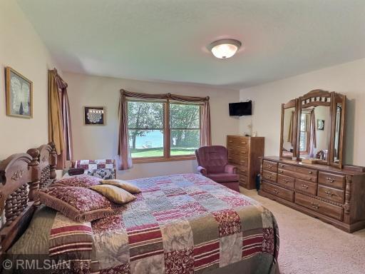 Large windows frame the natural beauty outside while filling the room with soft, natural light - perfect for unwinding after a lake day.