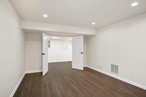 Extra workshop beyond the exercise room that accesses a crawlspace.