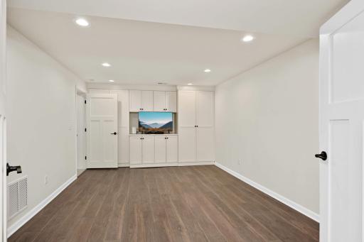 Great workout room or kids playroom has built-ins and LVT flooring