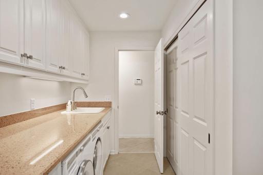 Lots of cabinets and closet space and solid surface countertops and sink