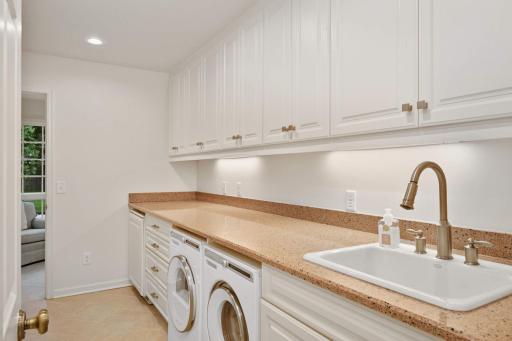 The Main floor laundry/mudroom is right off the 3 car attached garage has Asko W & D and Uline beverage refrigerator