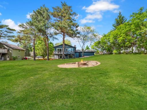 A spacious backyard retreat complete with a fire pit, perfect for relaxing evenings and outdoor gatherings.