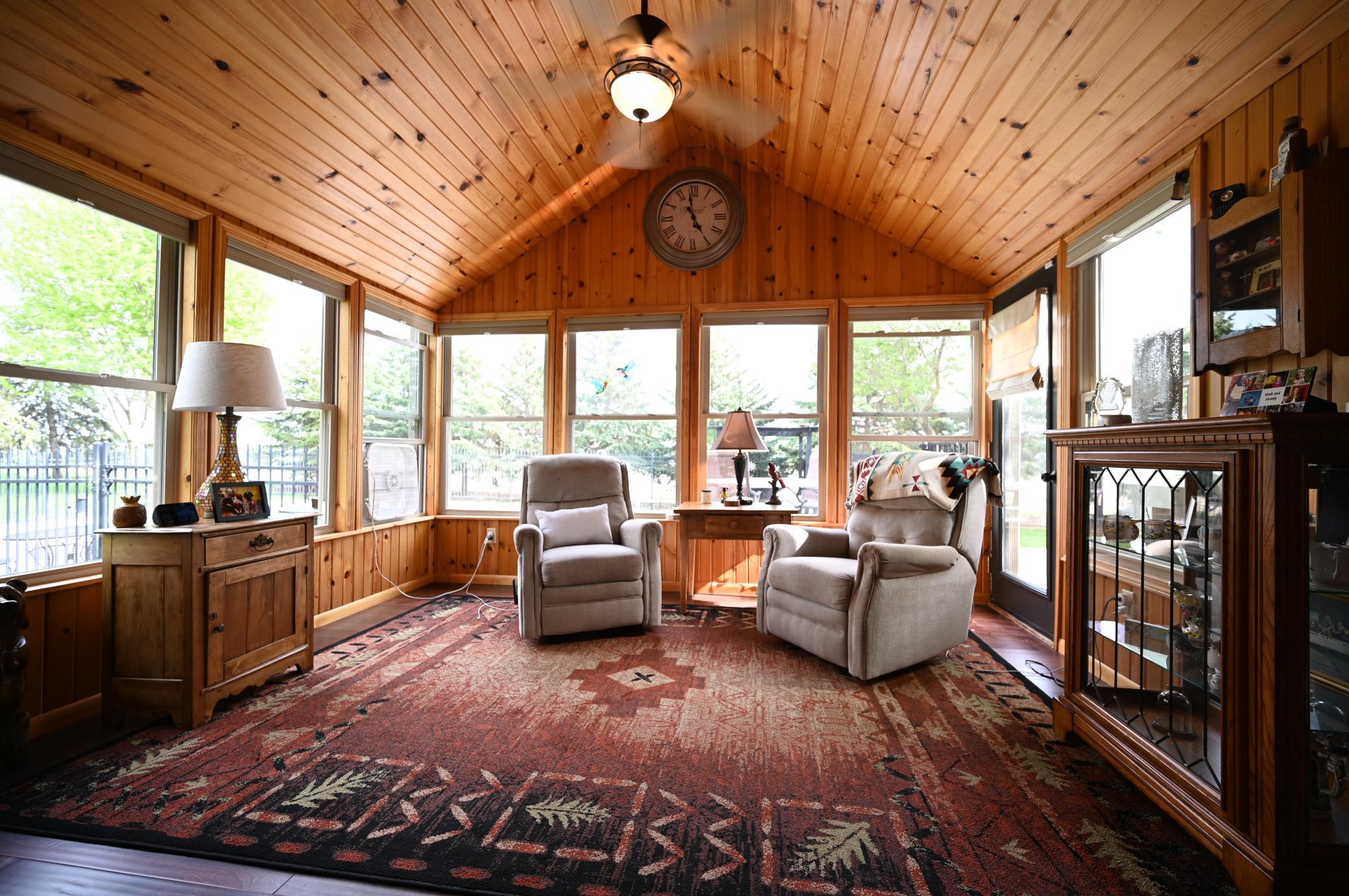 Beautiful porch with fireplace overlooking the pool and backyard.