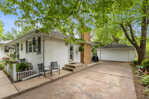Side view of home with detached 2 car garage. Many beautiful perennials throughout the front and backyard.