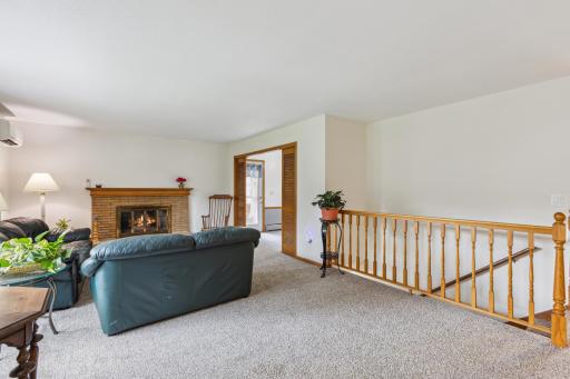 Natural light abounds throughout the spacious living room that opens to casual dining area.