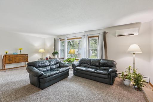 Spacious living room with expansive, beautiful wall of windows. Let the amazing natural light shine in to brighten up your day.