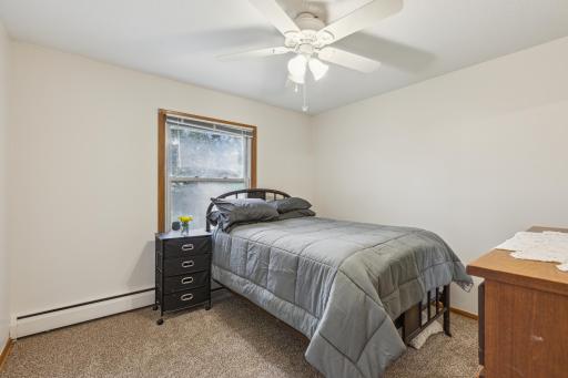 Bedroom 2 with ceiling fan, closet and great backyard view.