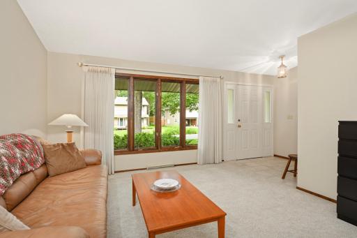 Inviting foyer and living room featuring a large picture window that fills the space with natural light.