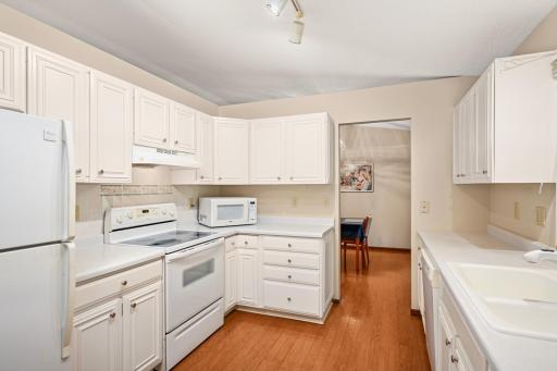 Beautiful hardwood flooring flows through the kitchen and dining room.