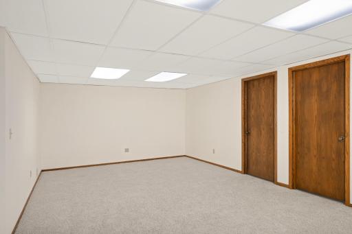 This view shows the added rec space that could be used for gaming. The two doors to the right lead to spacious rooms that could easily be bedrooms with the addition of egress windows.
