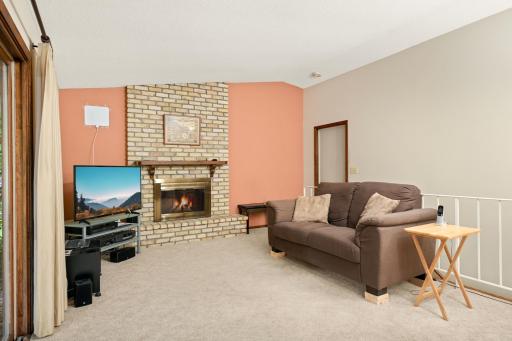The door provides access to the garage, while the stairway to the lower level is located behind the sofa.
