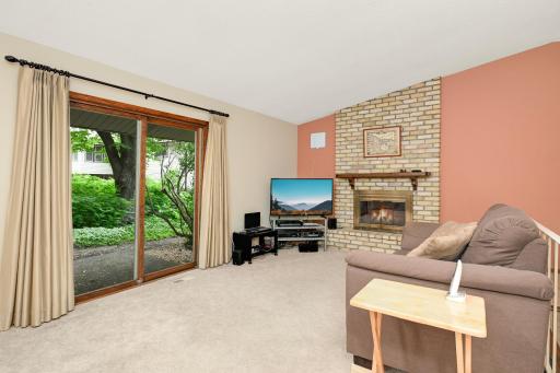 A comfortable family room with easy access to the patio and a cozy wood burning fireplace.