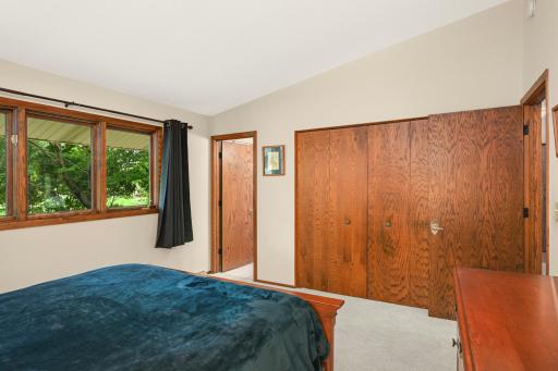 This angle highlights the primary bedroom’s direct access to the private ¾ bath.