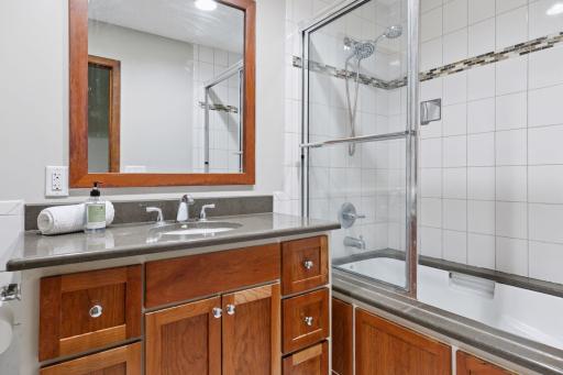 Full hall bath features a deep soaking tub and shower with fully tiled surround.